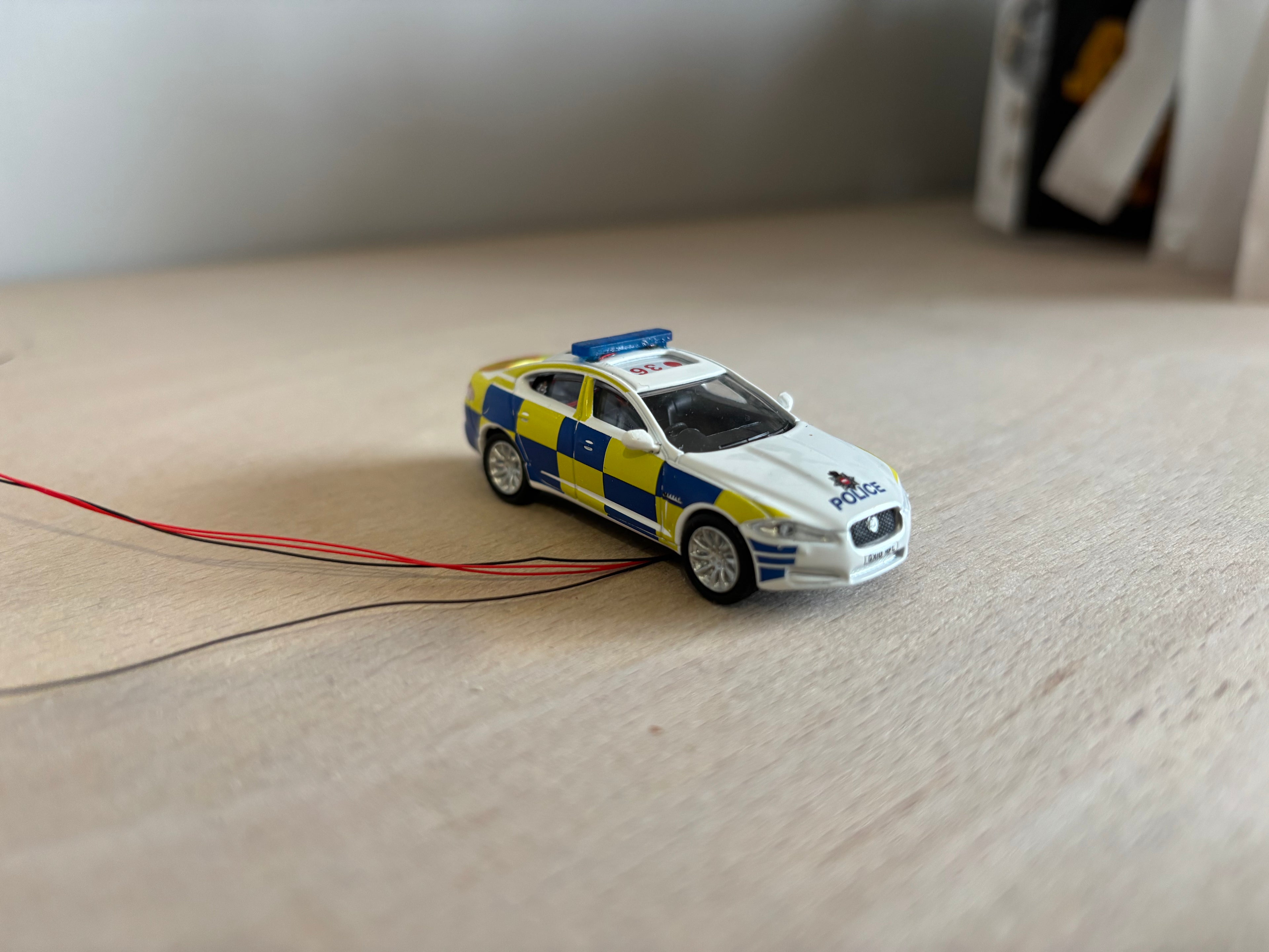 1:76 scale Oxford diecast Jaguar XF with flashing lights